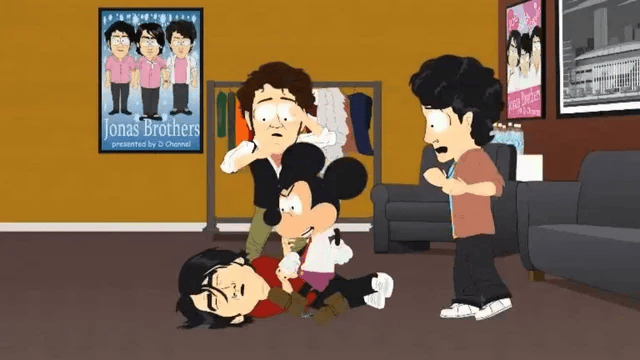 An animated scene in the visual style of the television show South Park depicts cartoon characters, including a recognisable Mickey Mouse figure, interacting in an indoor room that features a "Jonas Brothers" promotional poster on the wall.